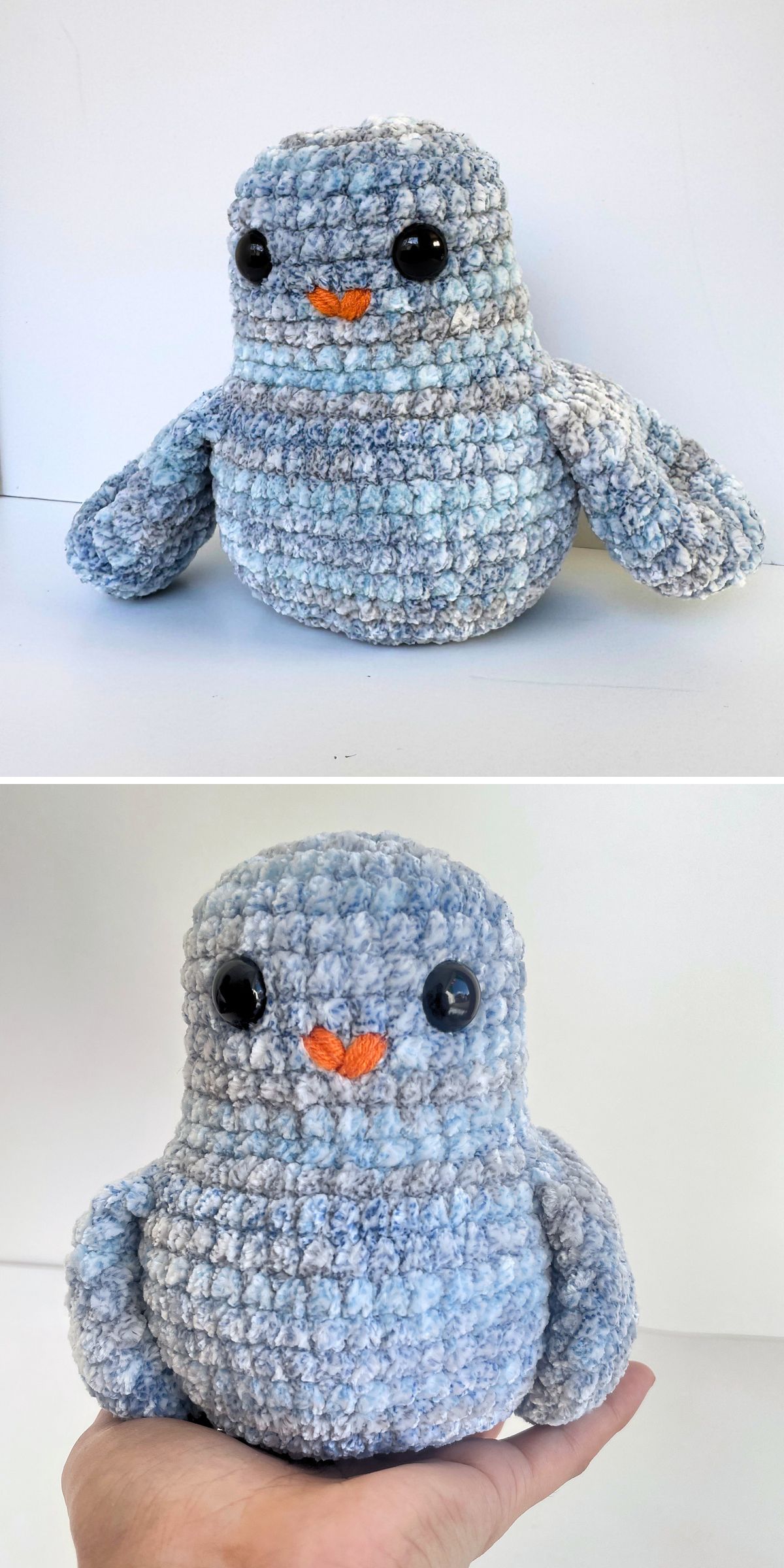 Plush crochet bird amigurumi made with soft blue-and-white chenille yarn, featuring large black eyes, a small orange beak, and rounded wings.