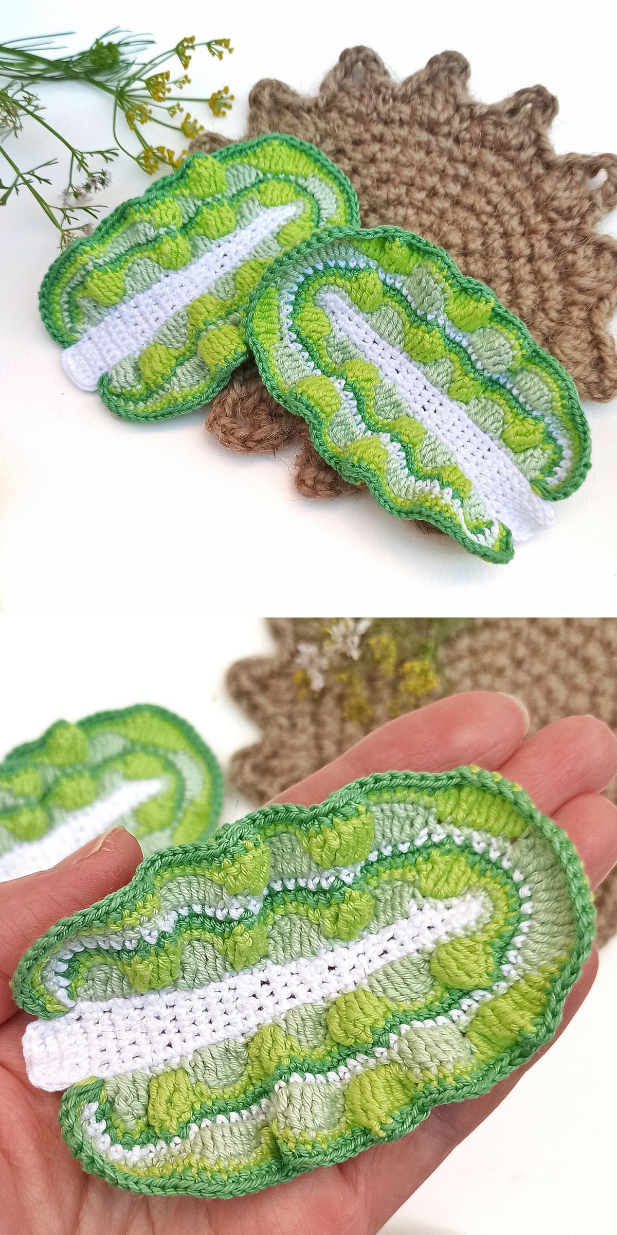 Two crocheted objects resembling lettuce leaves in shades of green and white are displayed on a textured brown crochet mat, with one leaf held in a hand for scale — perfect inspiration for anyone seeking unique crochet vegetable patterns.