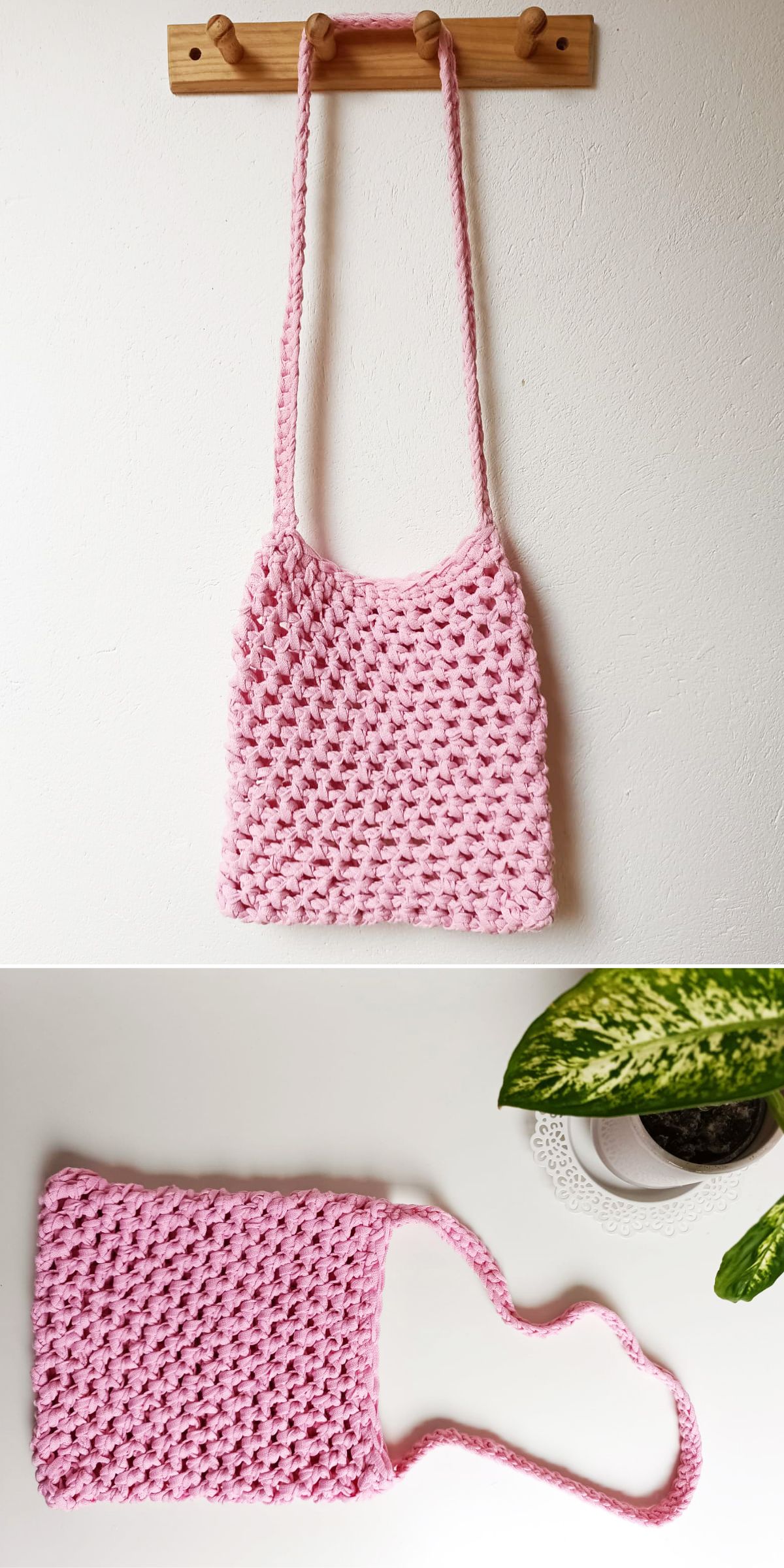 A handmade, light pink crochet crossbody bag is shown hanging on a wooden hook and laid flat on a white surface next to a green potted plant.