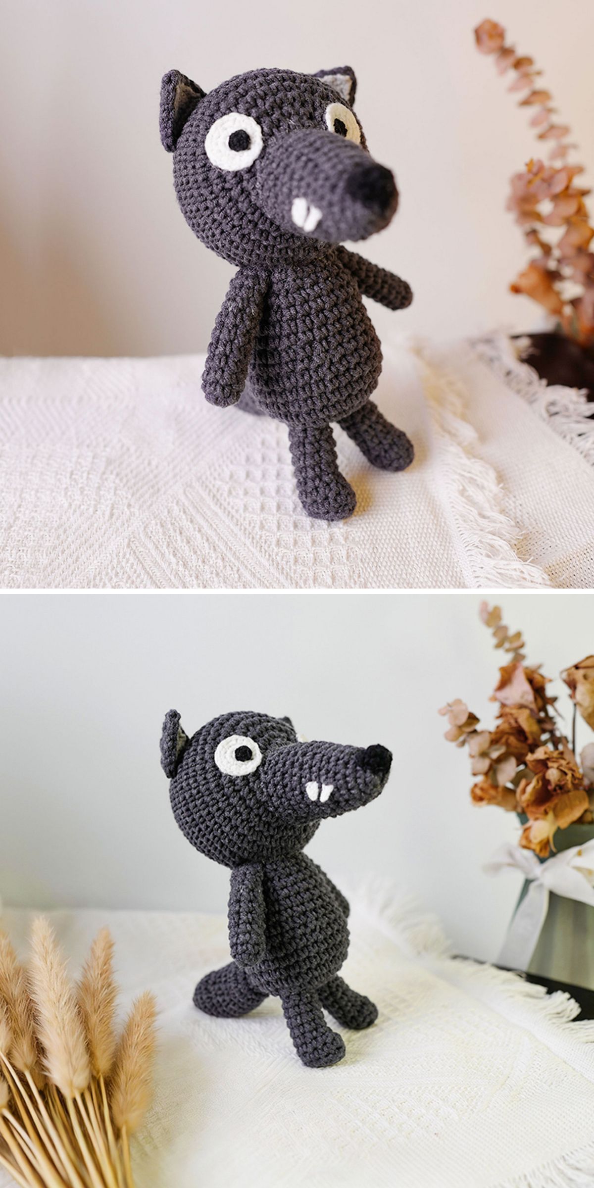 A crochet animal, this black wolf doll stands on a textured white surface with dried plants in the background.