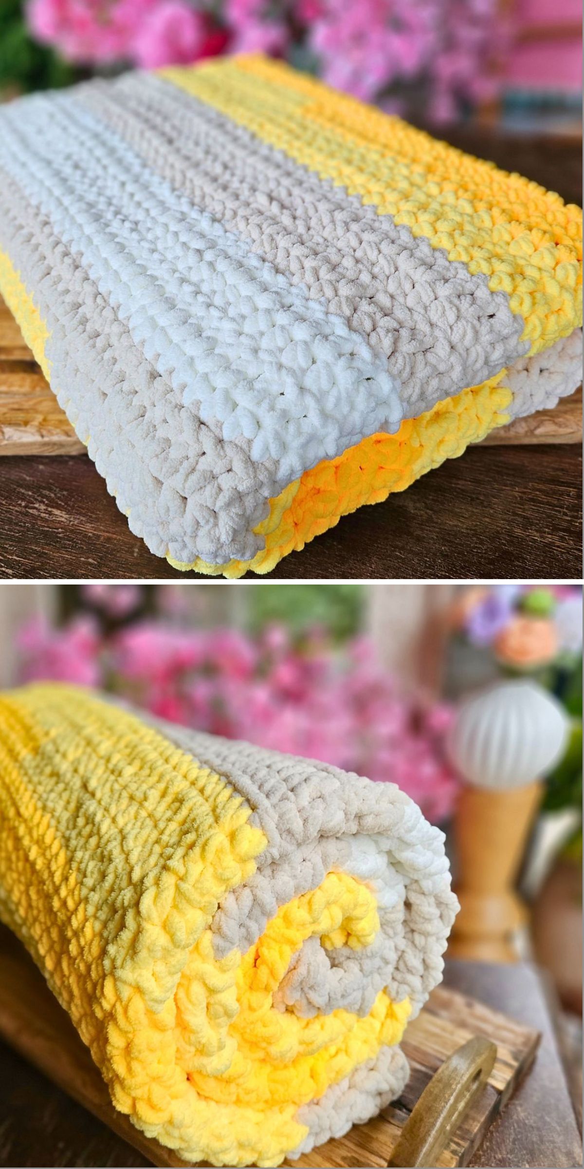 A folded and rolled crochet chunky blanket with beige, white, yellow, and orange stripes is placed on a wooden surface with a blurred floral background, offering cozy inspiration for anyone searching for crochet chunky blanket patterns.