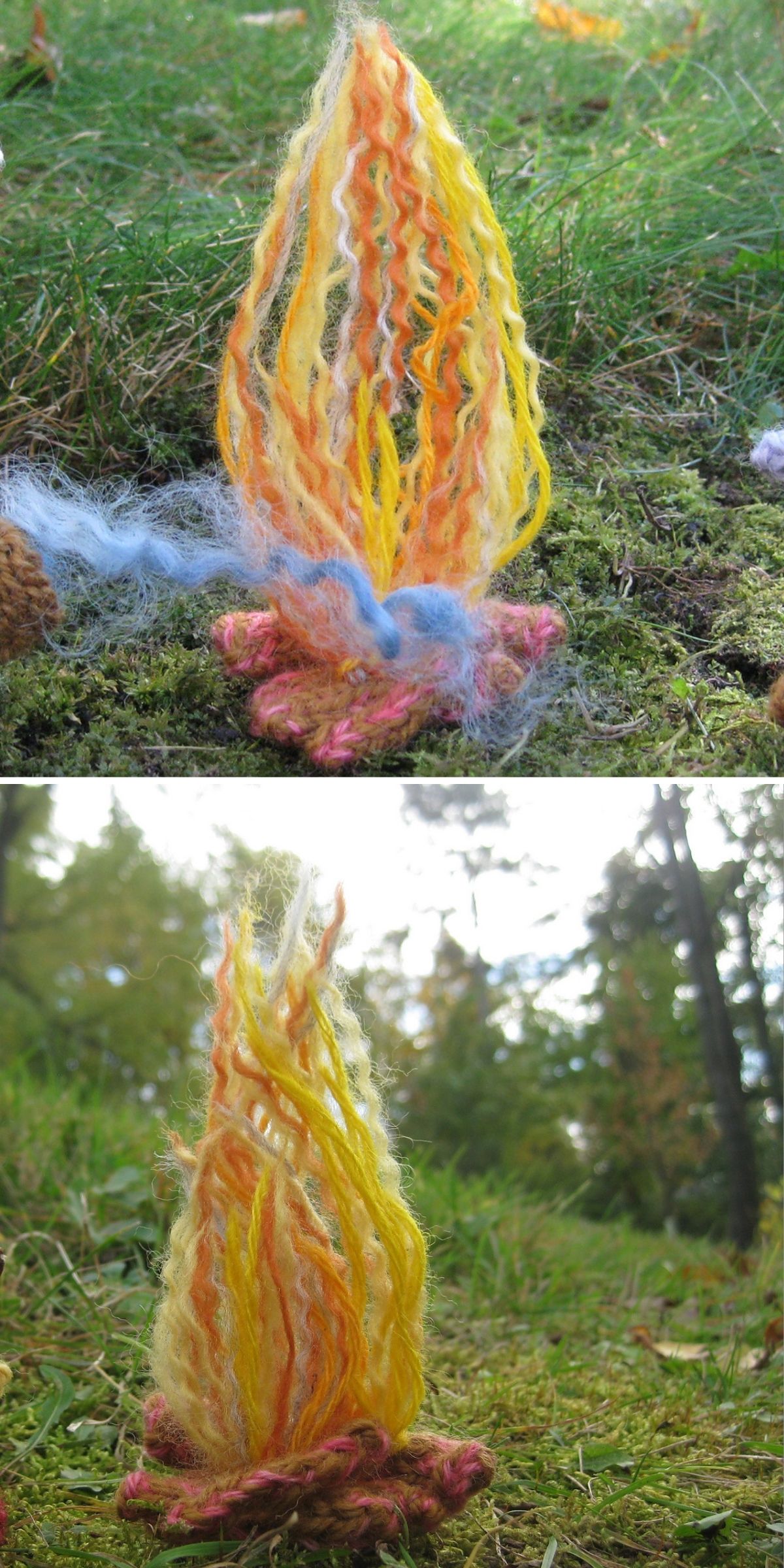 A small campfire-shaped knit toy made of yellow, orange, pink, and blue yarn sits on green grass and moss outdoors.