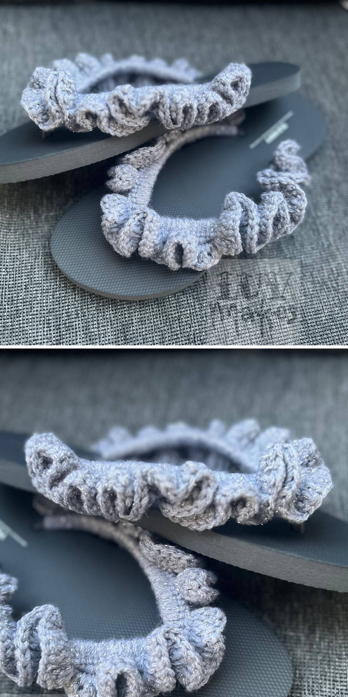 A pair of dark flip-flops with light gray, ruffled crochet cozy straps displayed on a gray fabric surface.