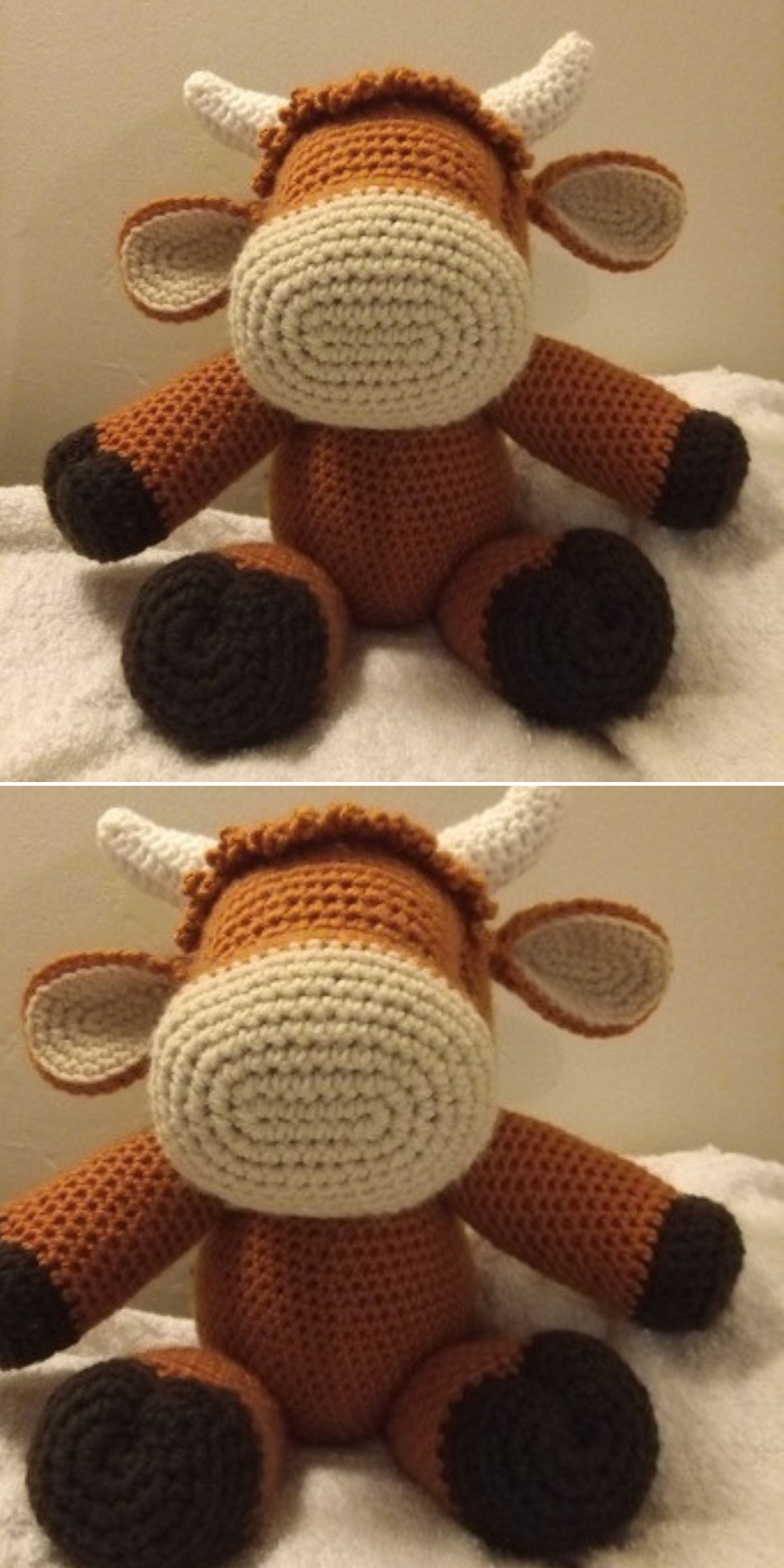 A crochet cow with a brown body, white snout and horns, and black hooves sits on a white fabric surface.