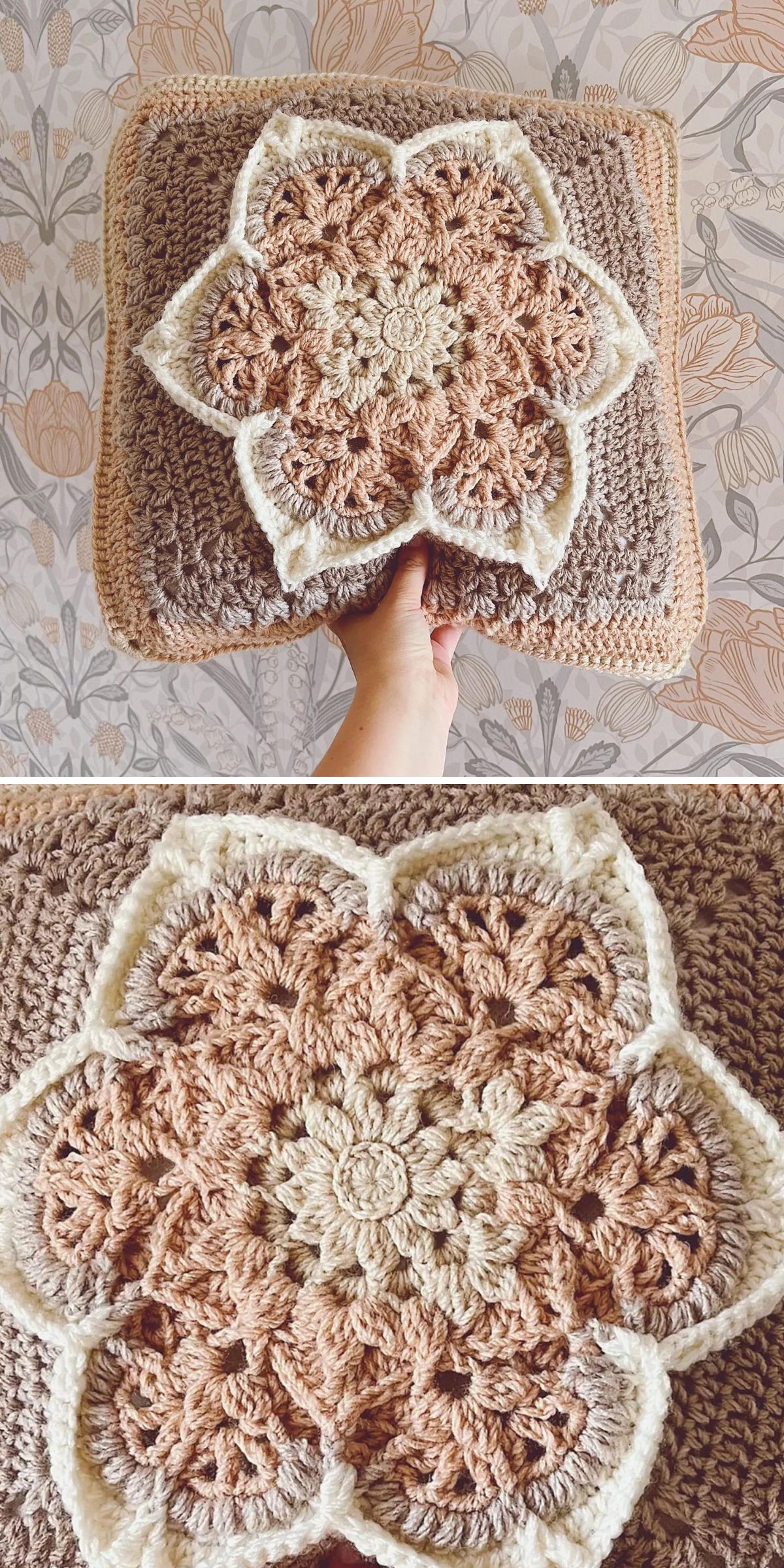 A hand holds a beautifully crafted crochet pillow featuring a raised, floral pattern in beige, cream, and brown yarn against a floral wallpaper background.
