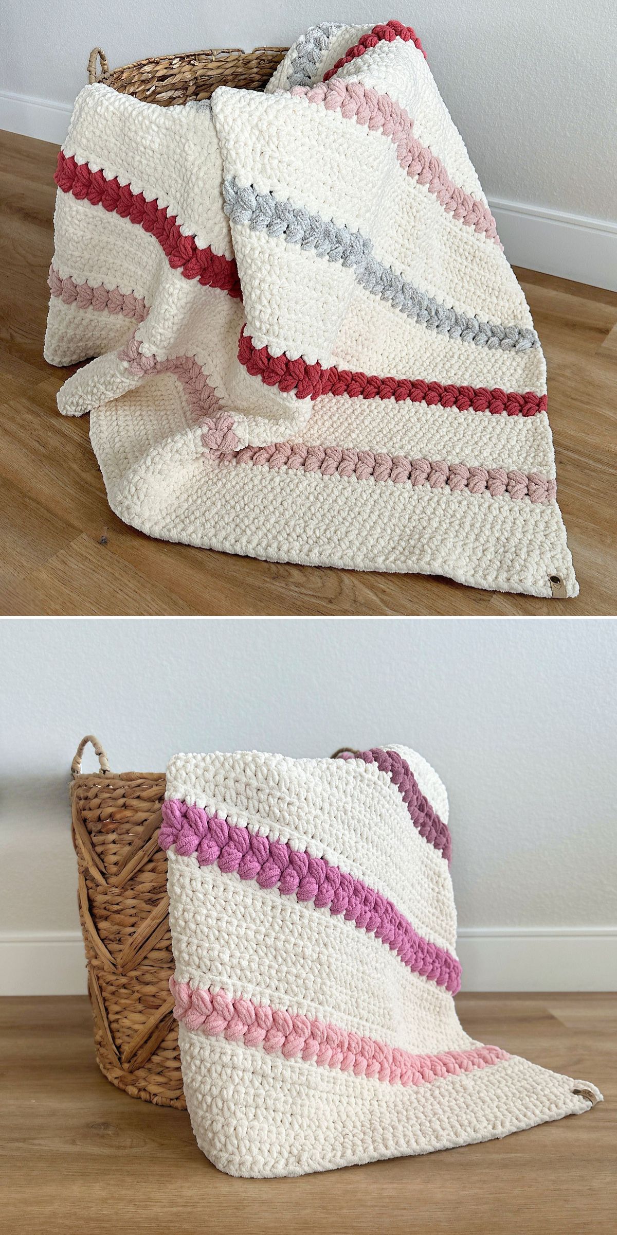 A woven basket on a wood floor holds a cream-colored crochet chunky blanket with horizontal pink, red, and gray stripes.