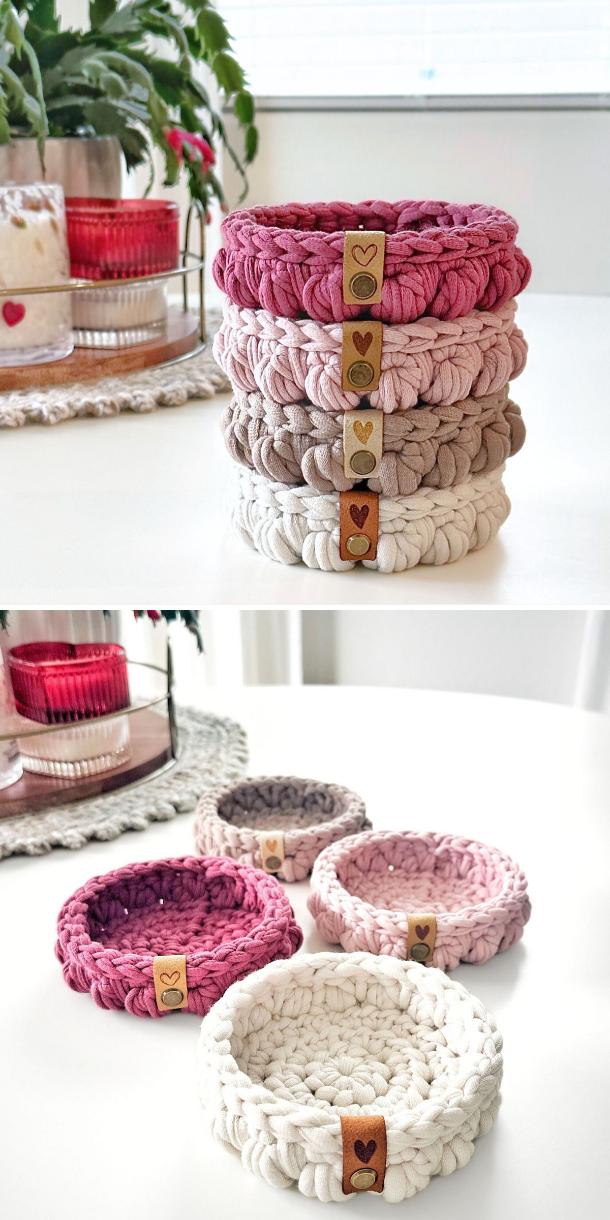 Four round crochet baskets in pink, mauve, and cream hues are stacked and displayed separately on a white table, with decorative items in the background.