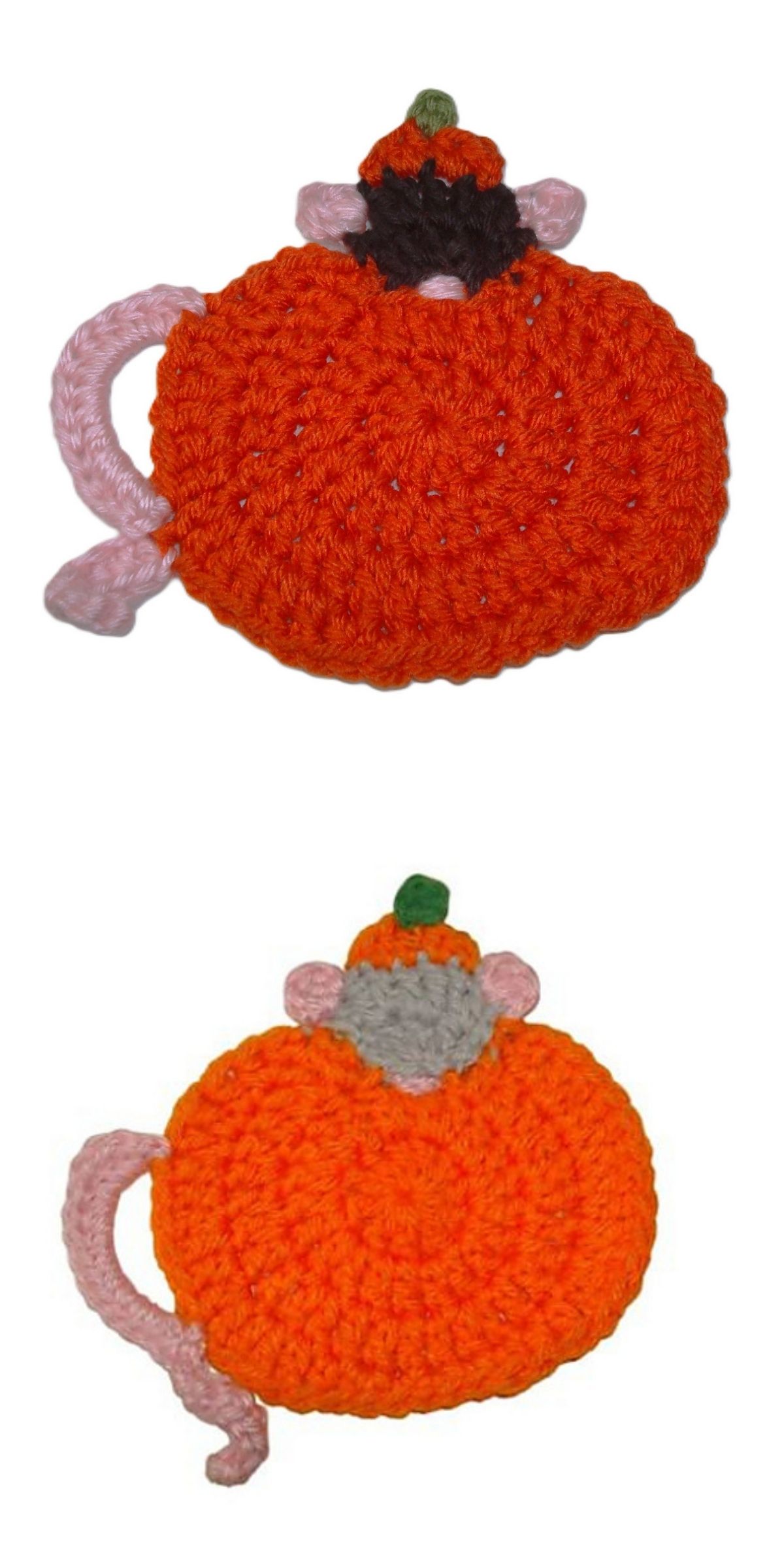 Two crocheted pumpkin-shaped coasters with pink tails, green stems, and small pink ears rest on a white background — perfect for a playful crochet Halloween coaster design.