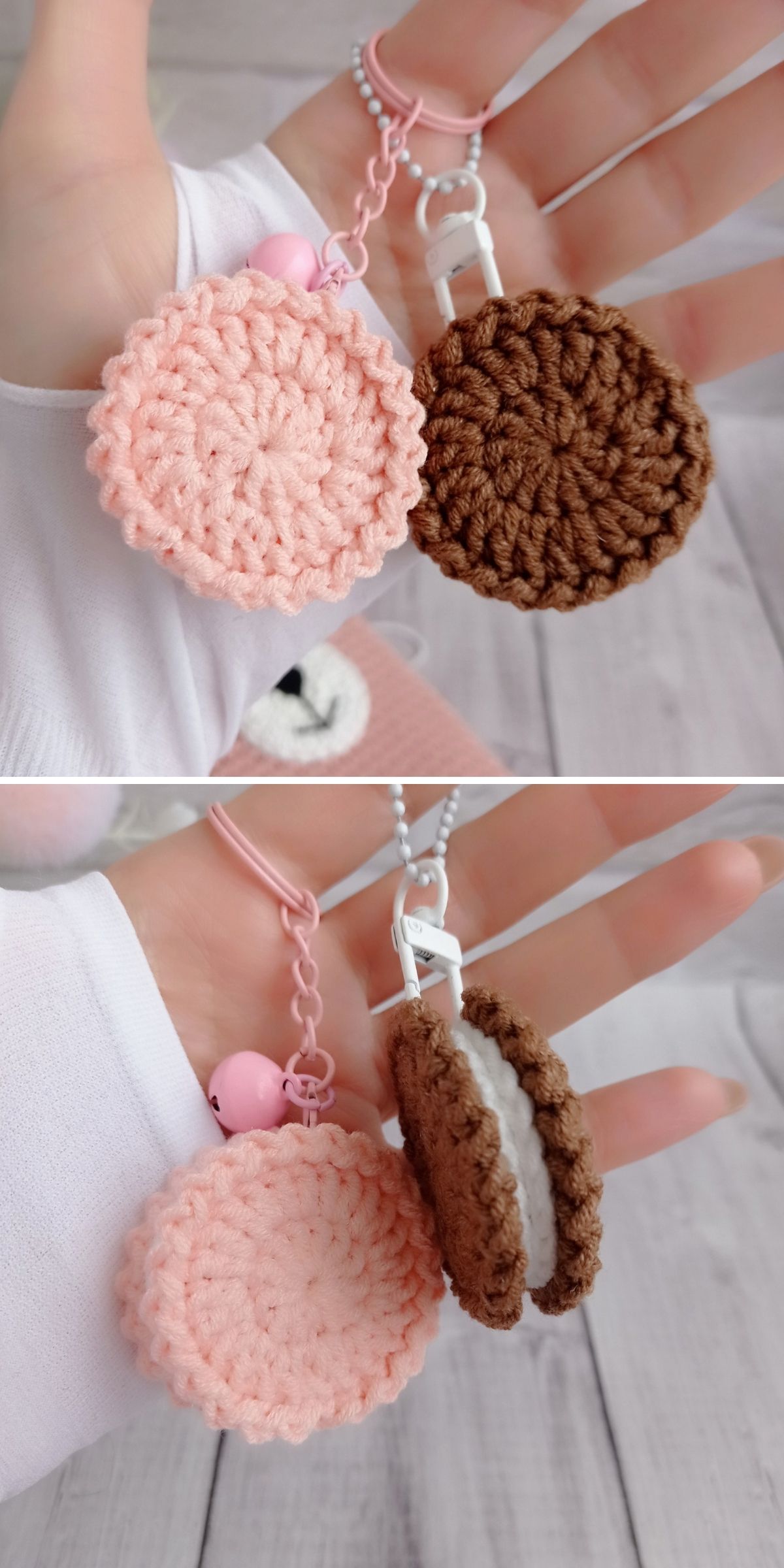 A hand holding two crochet dessert keychain charms: one circular pink charm and one brown-and-white sandwich cookie charm.
