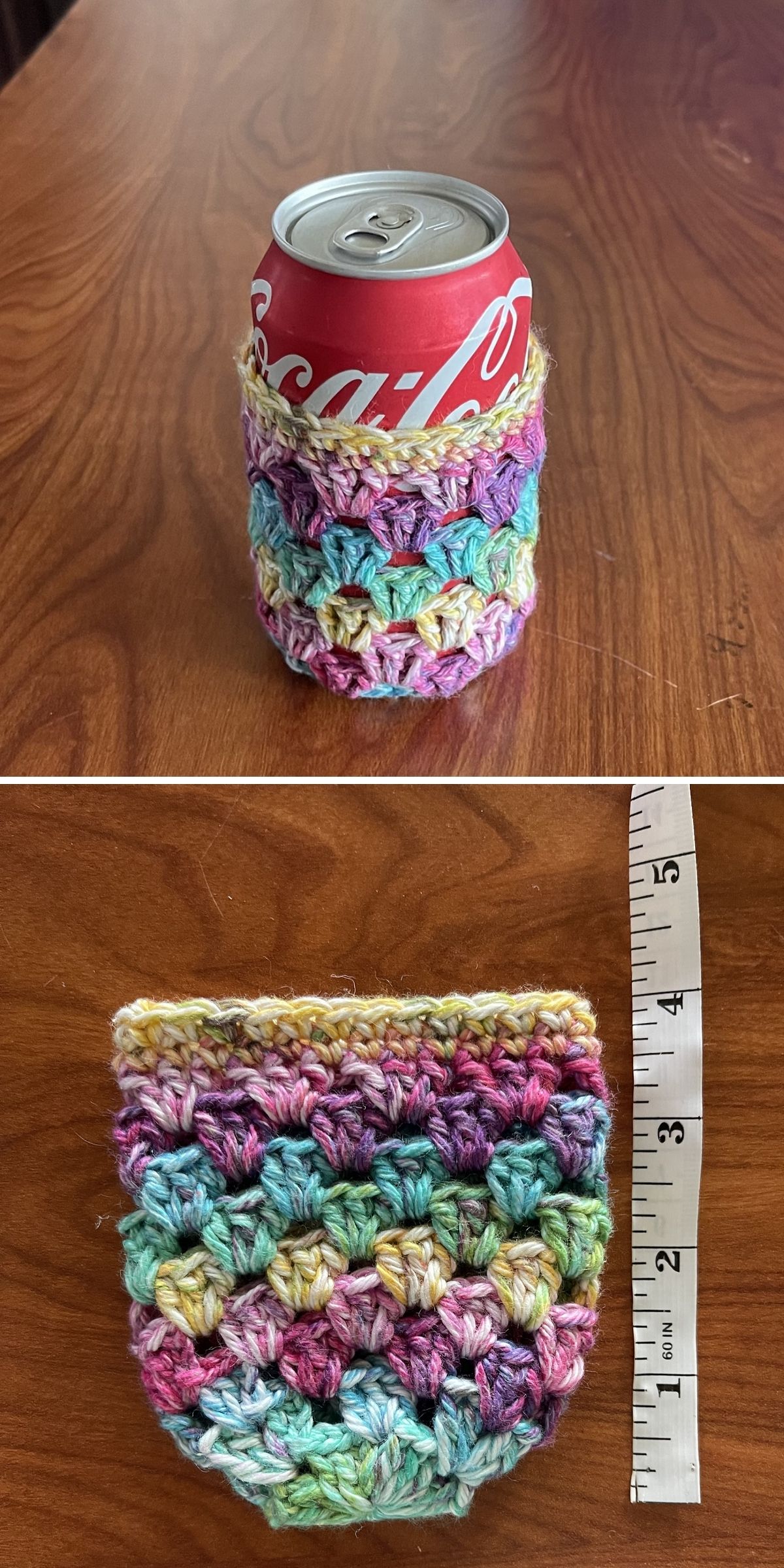 A Coca-Cola can inside a multicolored crochet mug cozy, shown next to a measuring tape indicating a height of approximately 4 inches.
