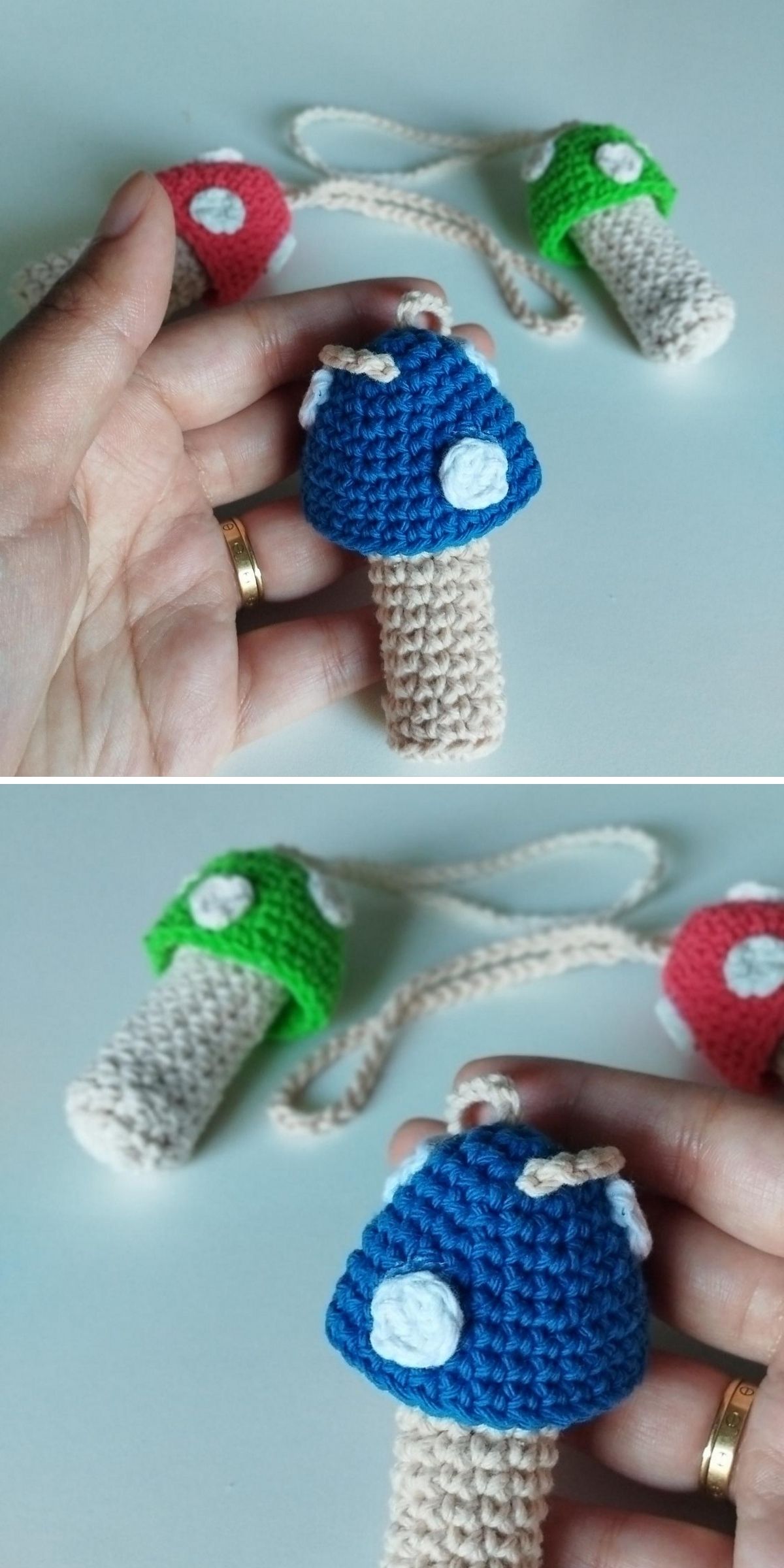 A hand holds a blue crochet mushroom with a beige stem and white spot. Other crochet mushrooms in green and red are visible in the background.