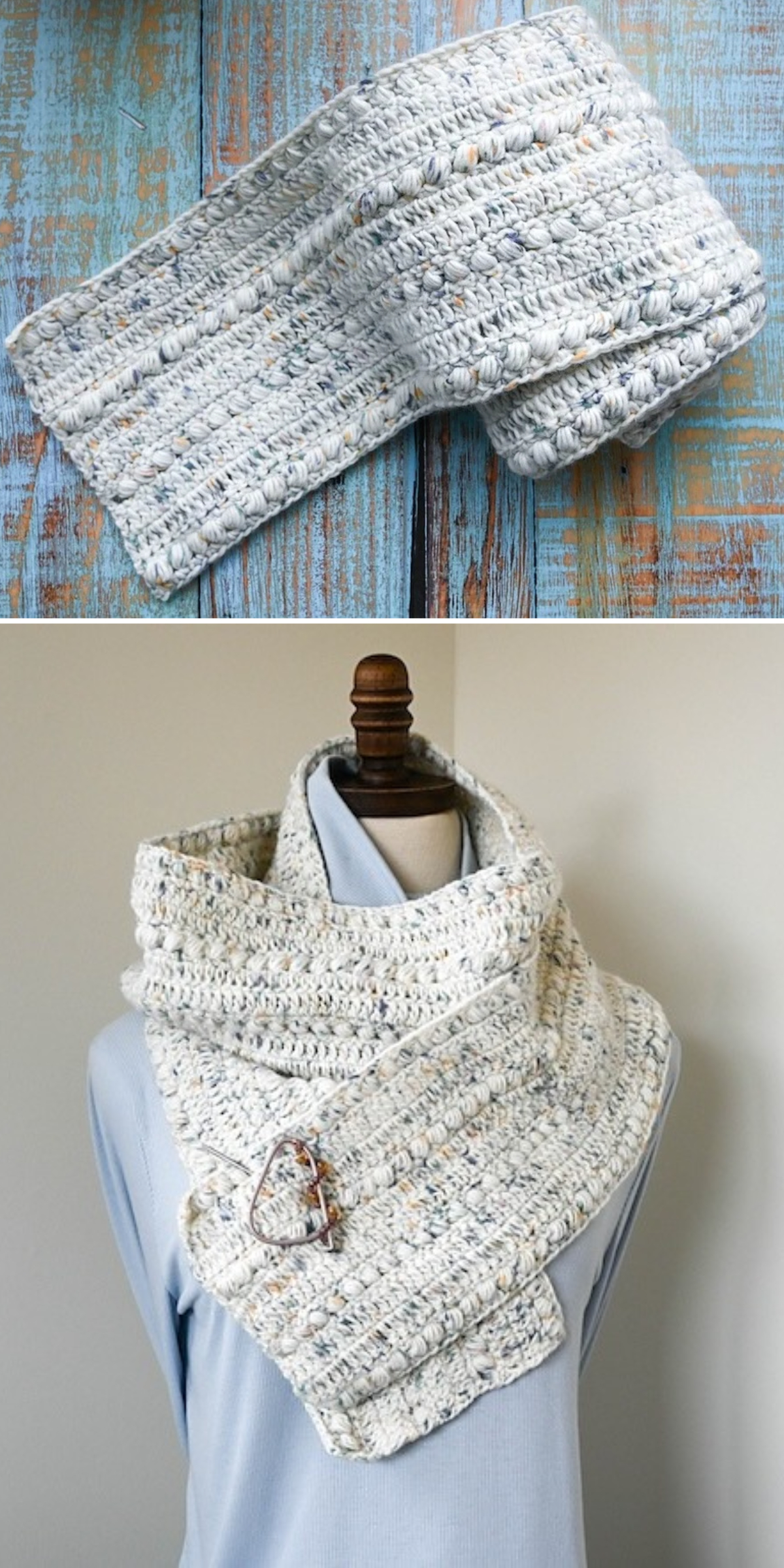 A long, textured, light-colored speckled crochet scarf draped on a mannequin and secured with a decorative pin.