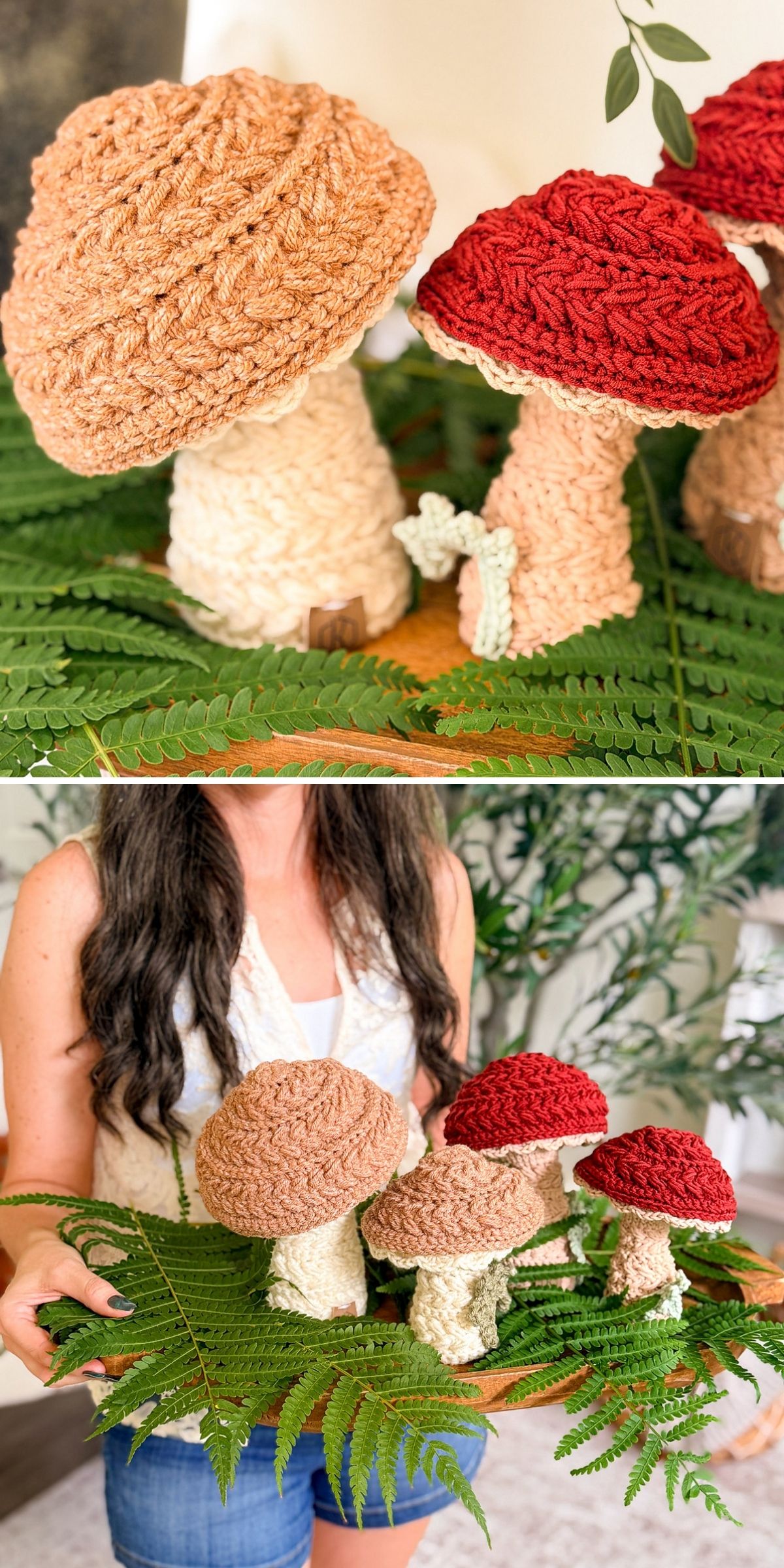 A person holds a wooden tray filled with several crochet mushroom decorations nestled among green fern fronds.